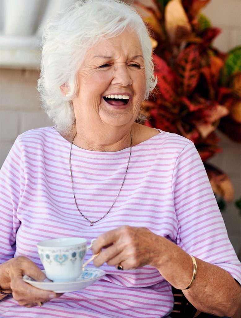 Woman smiling with a mug